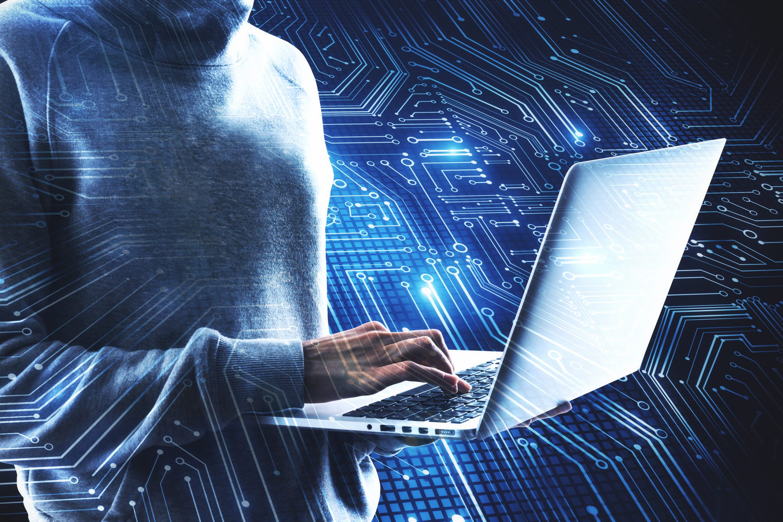 hooded-figure-uses-laptop-with-circuit-board-overl-2026-03-26-05-12-25-utc