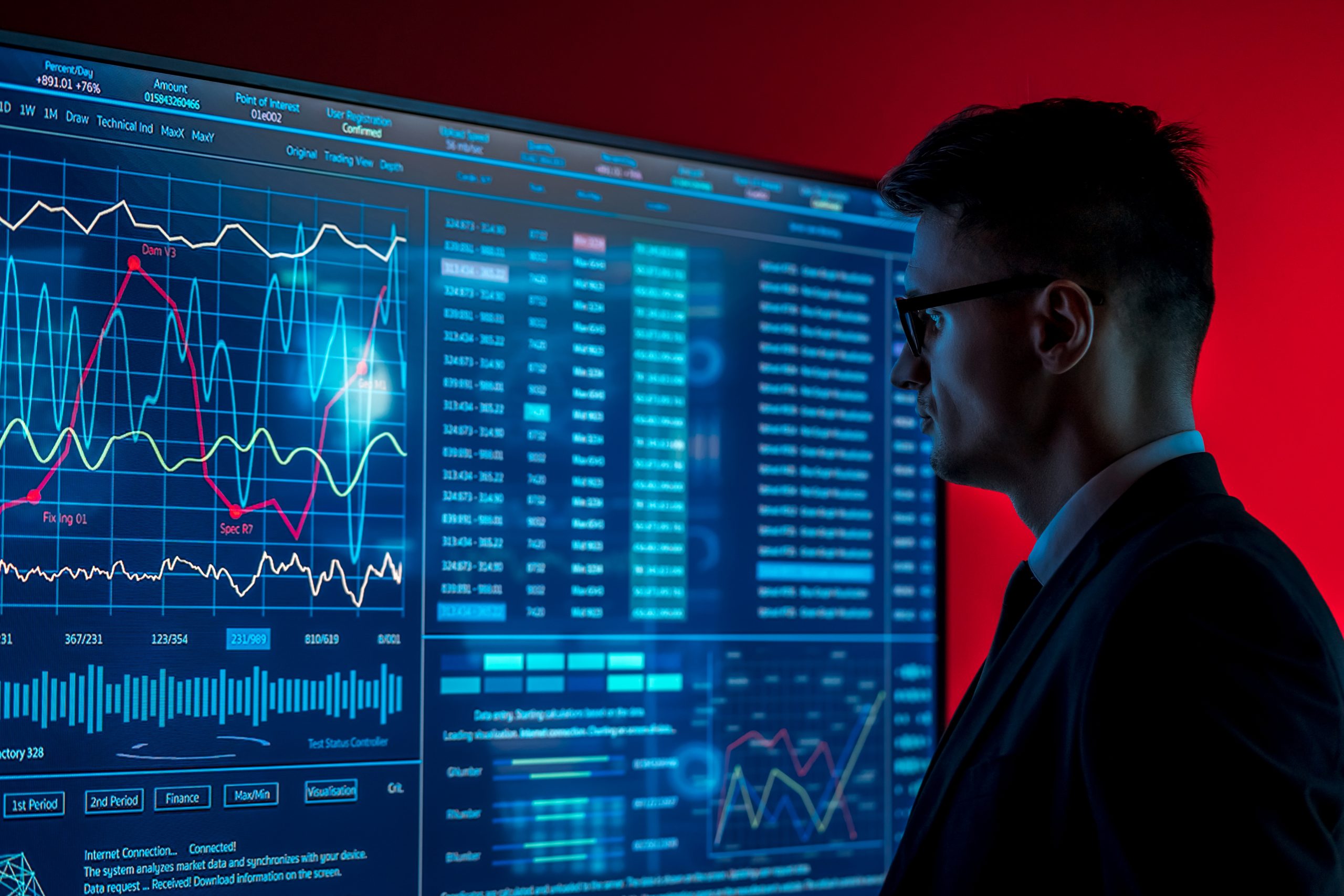 The man in suit looks on a blue screen with some data